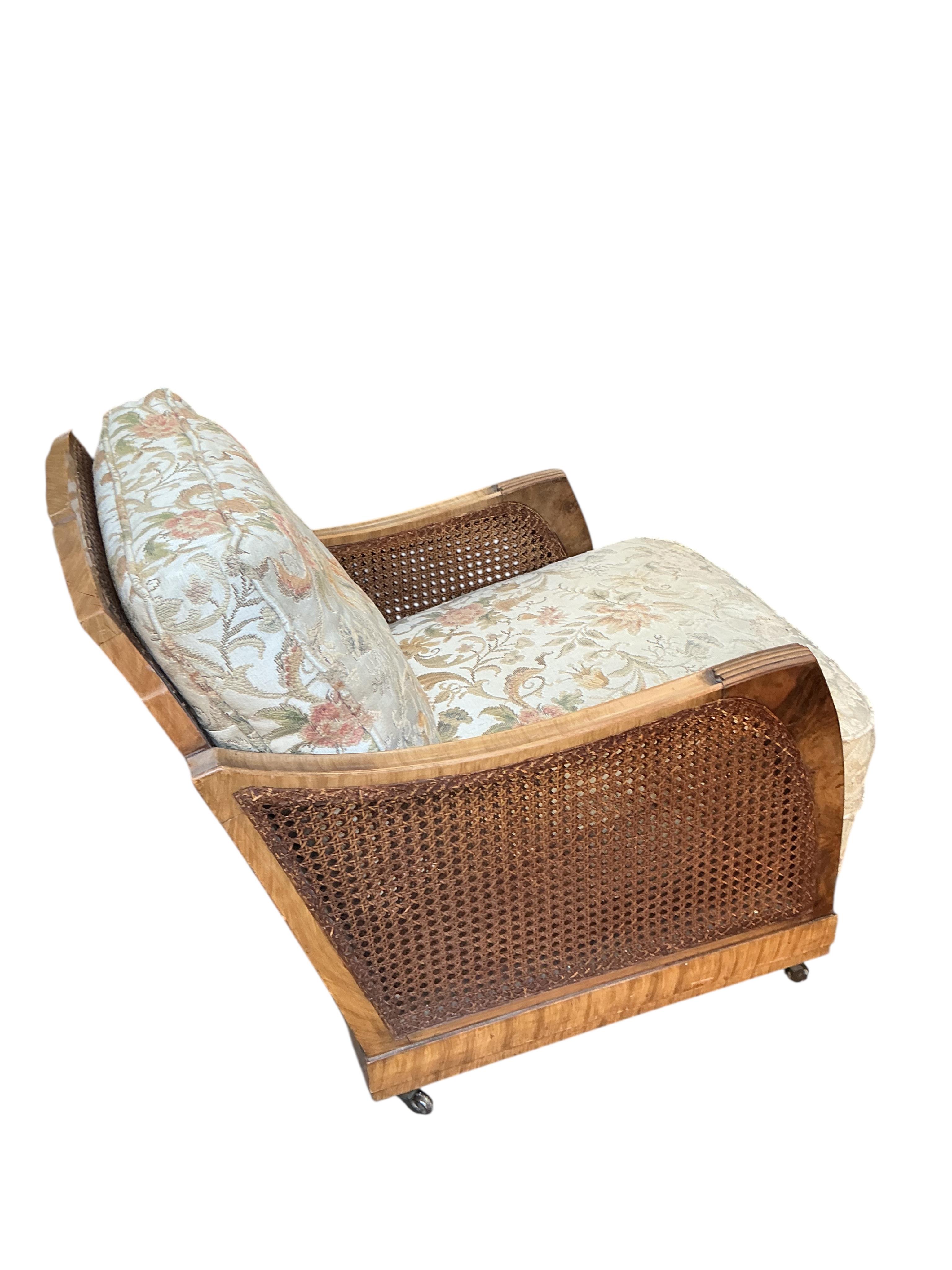 A Maple and Co. Art Deco walnut bergere armchair, width 66cm, depth 90cm, height 73cm